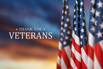 American flags with Text Thank You Veterans on sunset background. American holiday banner.