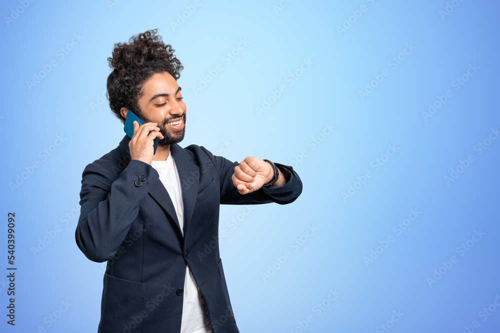 Middle eastern businessman have a phone call, copy space blue ba Middle eastern businessman have a phone call, copy space blue ba
