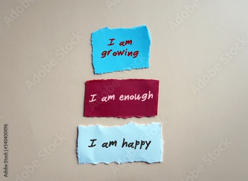 Cuadro en lienzo Torn paper note with handwritten text I AM GROWING I AM ENOUGH I AM HAPPY - posi