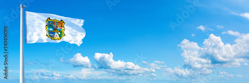 Tamaulipas, state of Mexico - flag waving on a blue sky in beautiful clouds - Horizontal banner photo