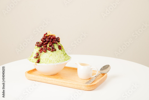 Matcha Japanese shaved ice. Snow ice with red beans toping and milk.