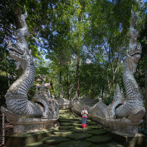 Asian woman at Wat Luang Khun Win Buddha temple with Lanna dress is located in Mae Win, Mae Wang District, Chiang Mai, Thailand. photo