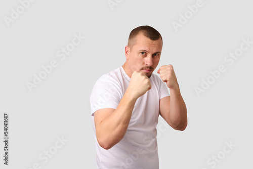 Portrait of a strong man posing on white background