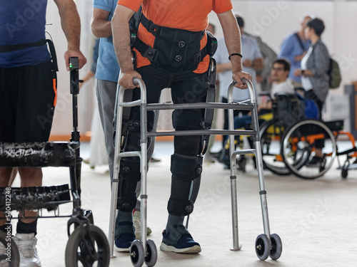 Photography Boy with Mobility Problems in Lower Limbs in Upright Posture Walking Thanks to a