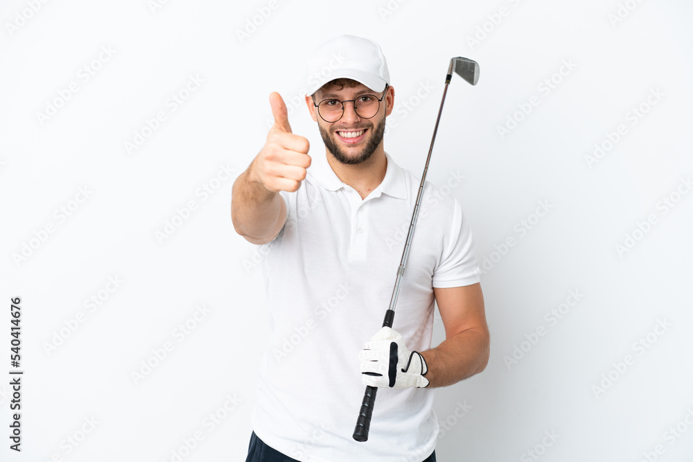 Handsome young man playing golf isolated on white background with thumbs up because something good has happened Handsome young man playing golf isolated on white background with thumbs up because something good has happened