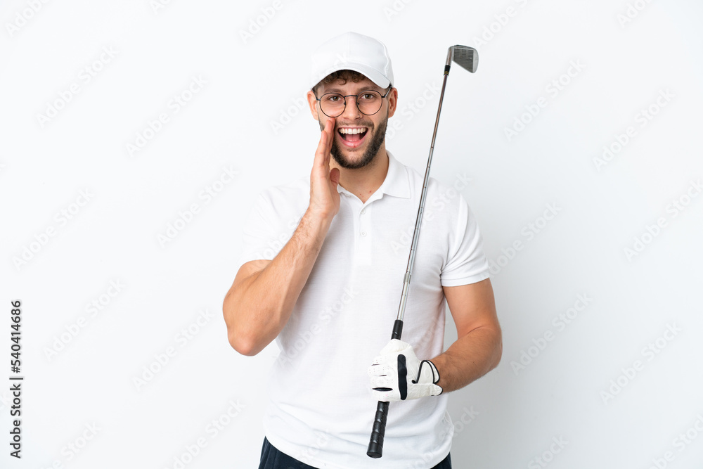 Handsome young man playing golf isolated on white background with surprise and shocked facial expression Handsome young man playing golf isolated on white background with surprise and shocked facial expression