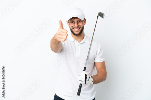 Handsome young man playing golf isolated on white background with thumbs up because something good has happened