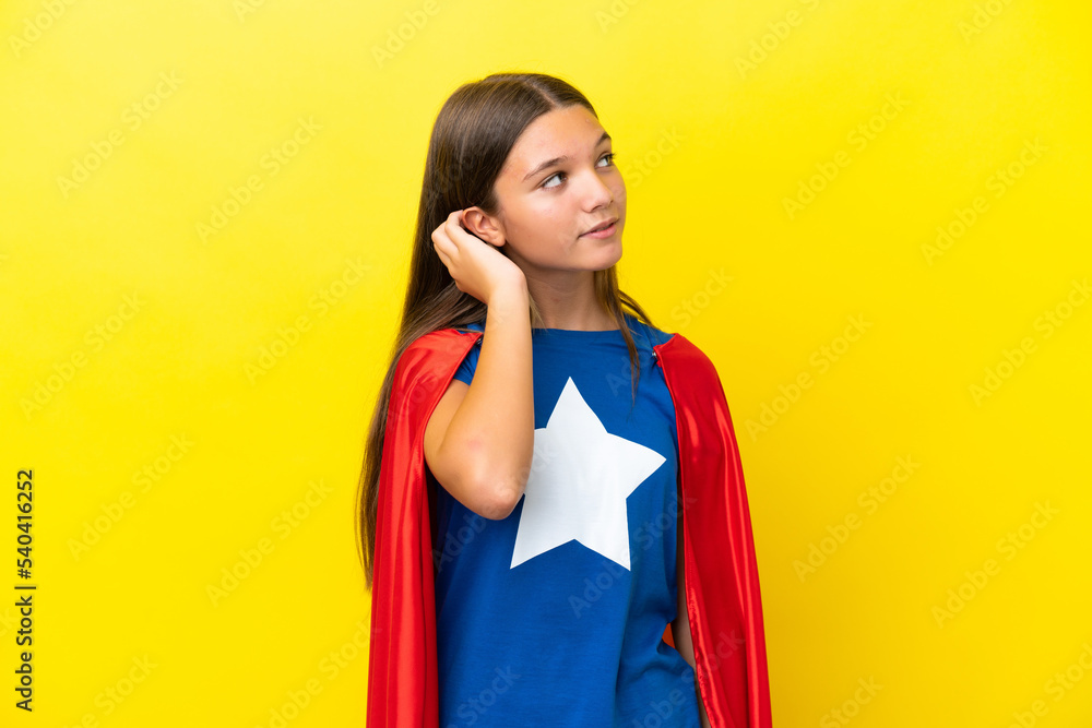 Little caucasian superhero girl isolated on yellow background thinking an idea Little caucasian superhero girl isolated on yellow background thinking an idea