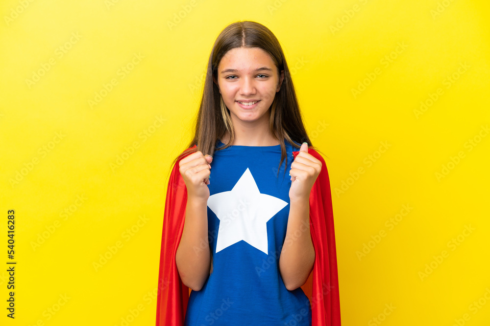 Little caucasian superhero girl isolated on yellow background celebrating a victory in winner position Little caucasian superhero girl isolated on yellow background celebrating a victory in winner position