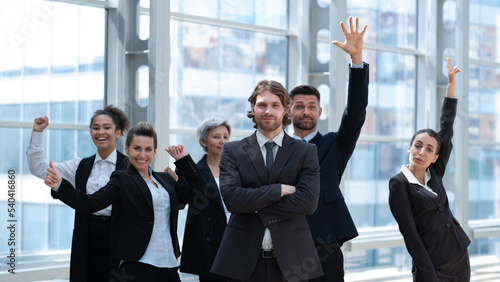 Business people with arms raised