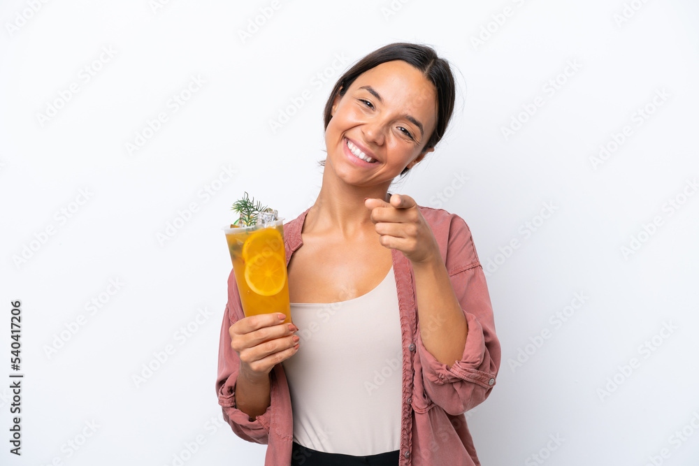 Young hispanic woman holding a cocktail isolated on white background pointing front with happy expression Young hispanic woman holding a cocktail isolated on white background pointing front with happy expression