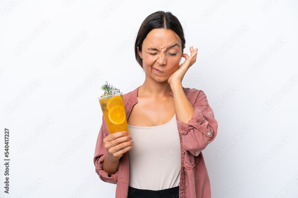Young hispanic woman holding a cocktail isolated on white background frustrated and covering ears Young hispanic woman holding a cocktail isolated on white background frustrated and covering ears