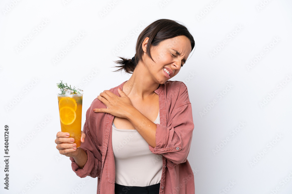 Young hispanic woman holding a cocktail isolated on white background suffering from pain in shoulder for having made an effort Young hispanic woman holding a cocktail isolated on white background suffering from pain in shoulder for having made an effort