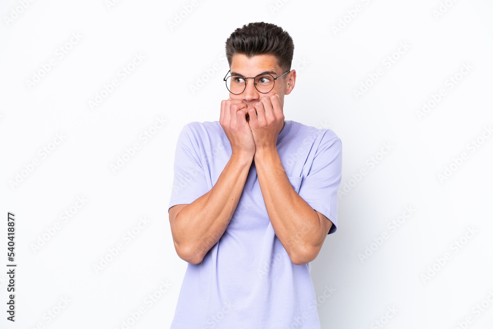 Young caucasian man isolated on white background nervous and scared putting hands to mouth Young caucasian man isolated on white background nervous and scared putting hands to mouth
