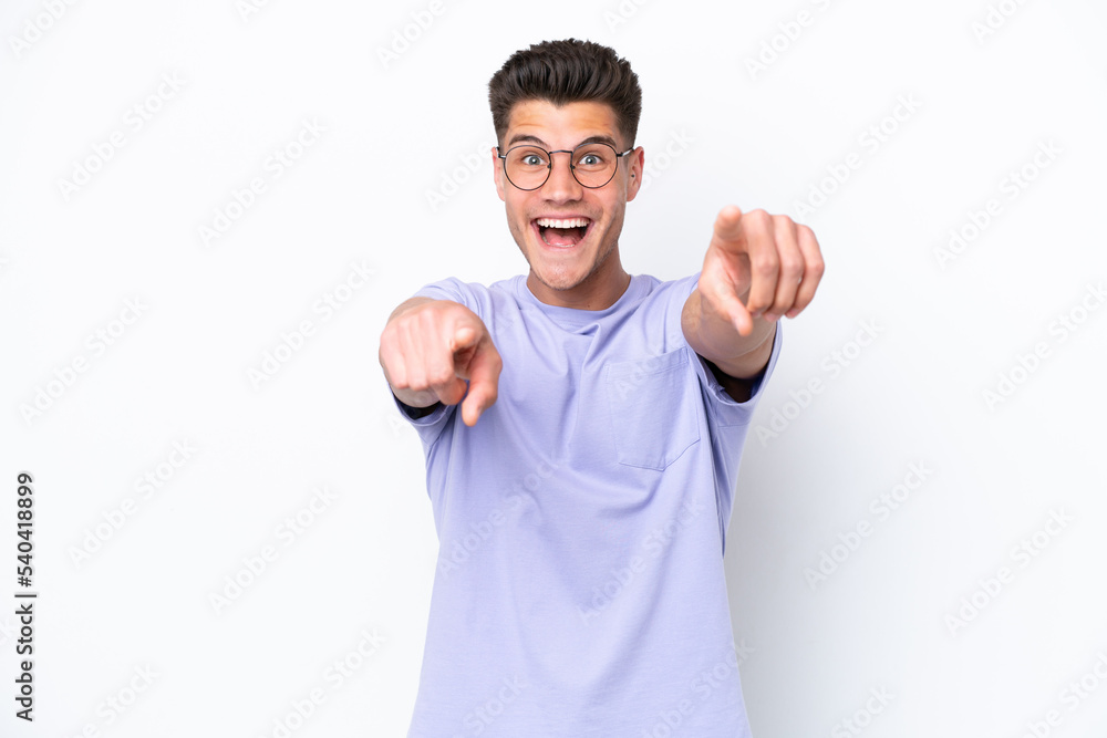 Young caucasian man isolated on white background surprised and pointing front Young caucasian man isolated on white background surprised and pointing front