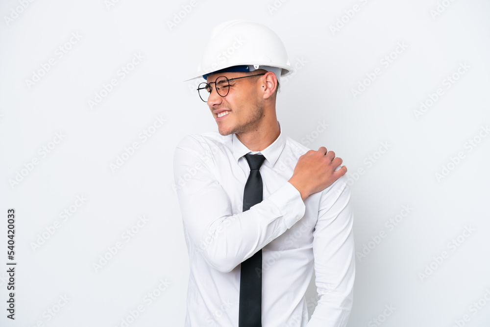 Young architect caucasian man with helmet and holding blueprints isolated on white background suffering from pain in shoulder for having made an effort Young architect caucasian man with helmet and holding blueprints isolated on white background suffering from pain in shoulder for having made an effort