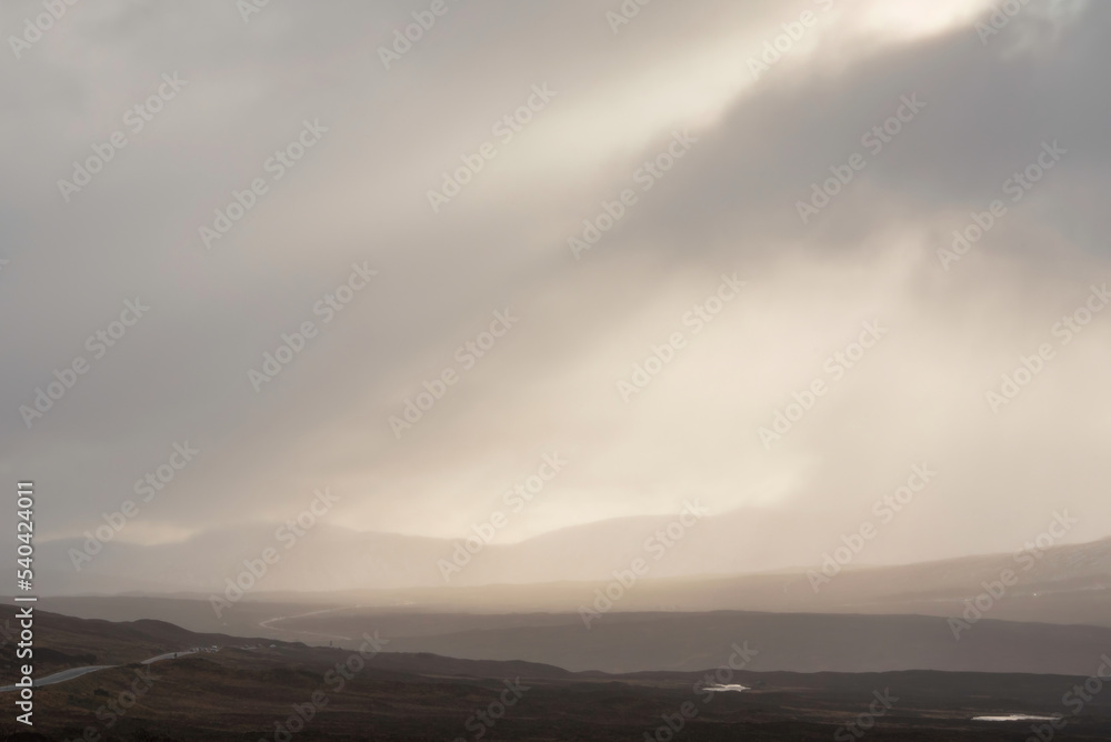 Beautiful Winter landscape image of view along Rannoch Moor during heavy rainfall giving misty look to the scene
