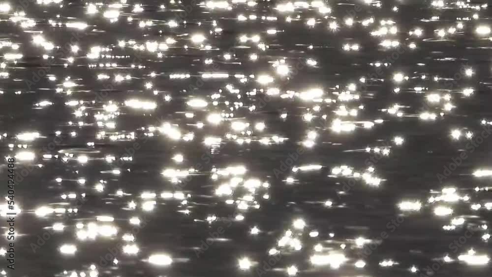 The glare of the sun in the water, sunspots in the black river, Sunlight with a very soft bokeh. The glare of the sun in the water, sunspots in the black river, Sunlight with a very soft bokeh.