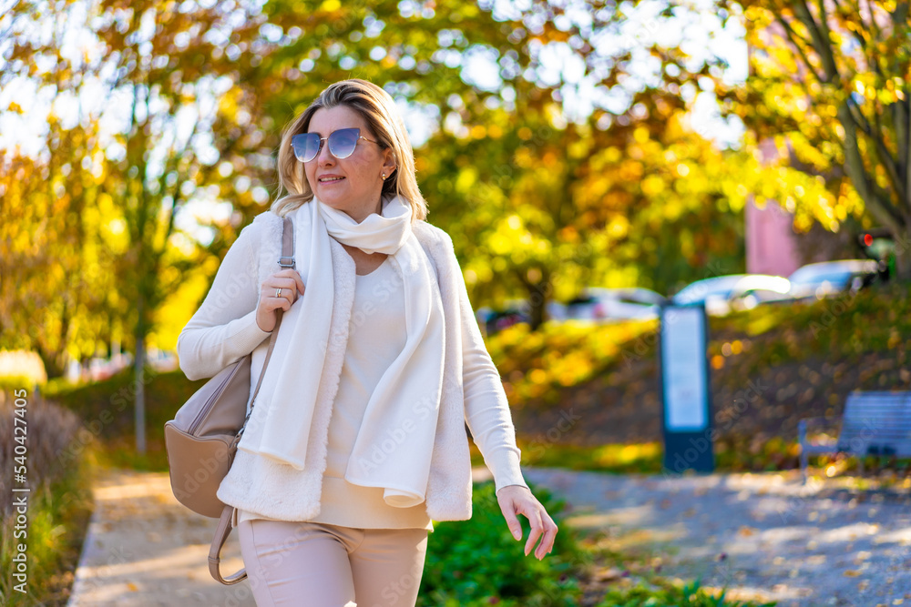 Beautiful woman walking in city park
Beautiful woman walking in city park