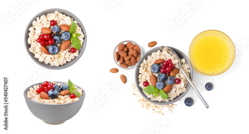 Set with tasty oatmeal porridge served with berries and nuts on white background