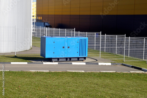 New blue mobile diesel generator for emergency power supply of the production complex.