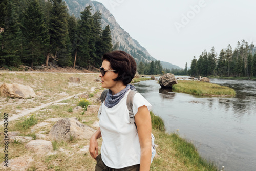 Portrait of smiling middle aged woman on nature background.