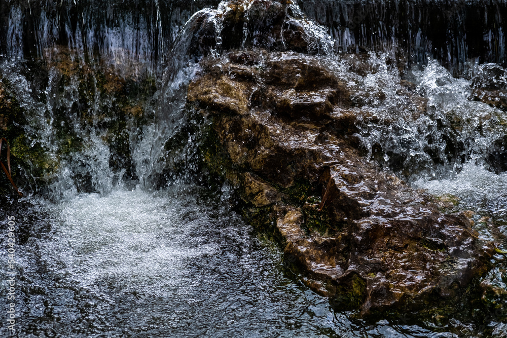 Fast and strong flow of water between large rocks. Fast and strong flow of water between large rocks.