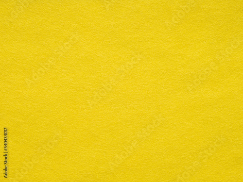 Background of bright yellow felt. Yellow cotton textile- close up of fabric texture. Full frame backdrop wallpaper of art and stationery work. Velvet pattern of mint woolen felt. Full frame wallpaper.