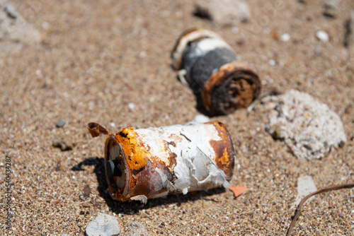 Obraz na płótnie Corroded batteries on sandy beach, environmental pollution w salonie