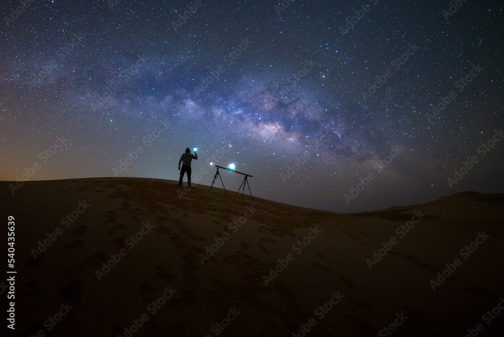 Photographer Camping in the sand dune desert with milky way star of Abu Dhabi, UAE.