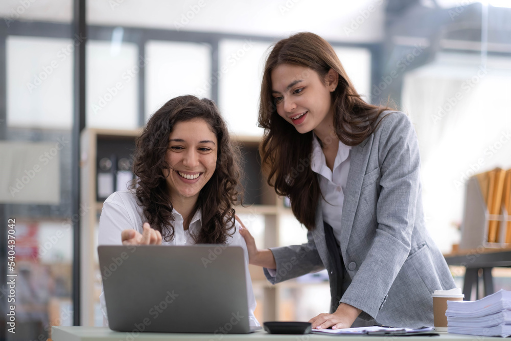 Two young Asian business woman talk, consult, discuss working with new startup project idea presentation analyze plan marketing and investment in the office. Two young Asian business woman talk, consult, discuss working with new startup project idea presentation analyze plan marketing and investment in the office.