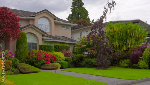 Wallpaper Mural Establishing shot of two story stucco luxury house with nice summer  landscape in Vancouver, Canada, North America. Day time on June 2022. ProRes 422 HQ. Torontodigital.ca