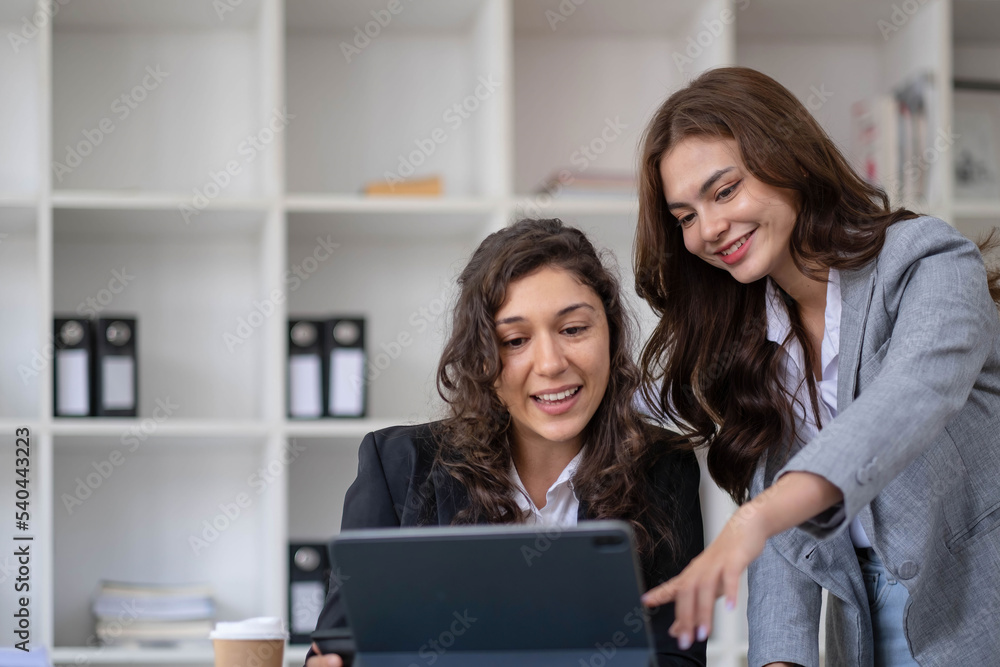 Two young Asian business woman talk, consult, discuss working with new startup project idea presentation analyze plan marketing and investment in the office. Two young Asian business woman talk, consult, discuss working with new startup project idea presentation analyze plan marketing and investment in the office.
