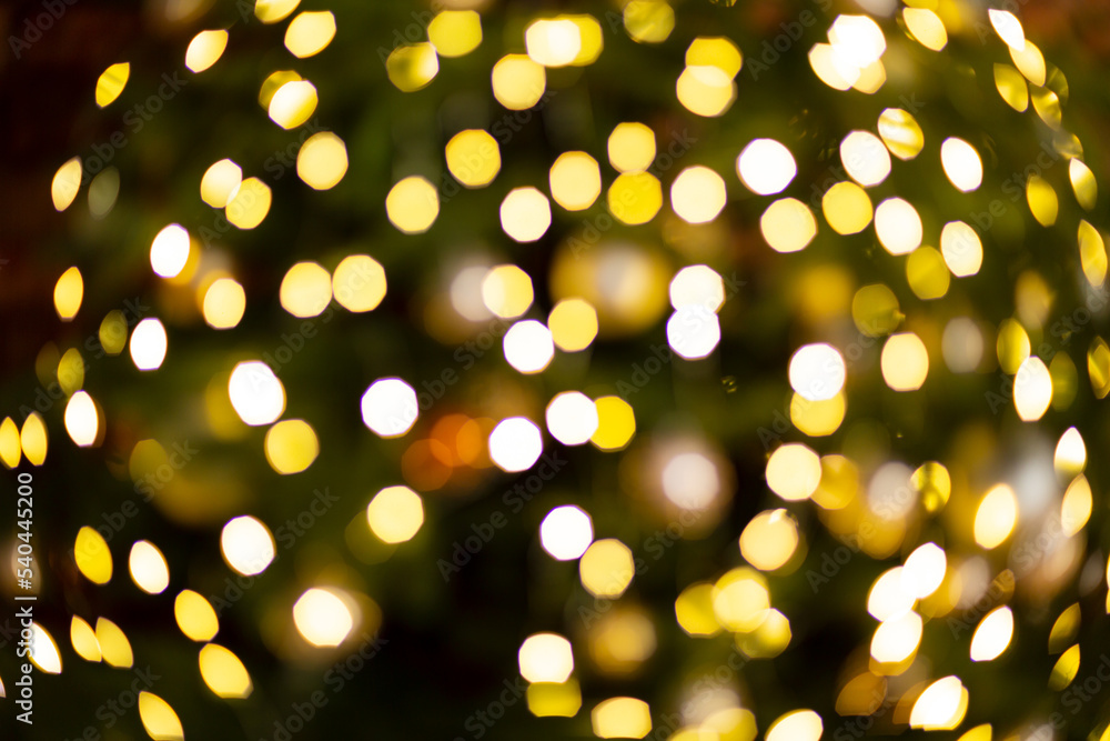 Christmas  tree and festive bokeh lighting, blurred holiday background yellow and green