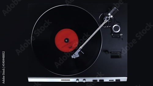 Top view on black turntable with rotating LP record. Gramophone playing vinyl disc.