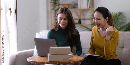 Portrait of Starting small businesses SME owners, two Asian woman check online orders Selling products working with boxs freelance work at home office, sme business online small medium enterprise