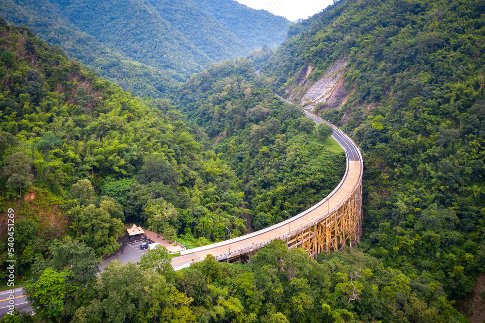 Naklejka premium Top view Aerial photo from flying drone over The highest bridge pier Phor Khun Pha Muang Bridge (Huai Tong at Phetchaboon Thailand.Bridge over the jungle.Bridge over mountain and green forest