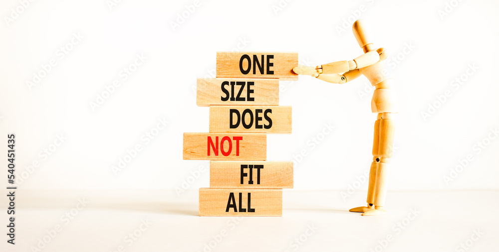 © Dzmitry - One size does not fit all symbol. Concept words One size does not fit all on wooden blocks. Businessman hand. Beautiful white background. One size does not fit all business concept. Copy space.