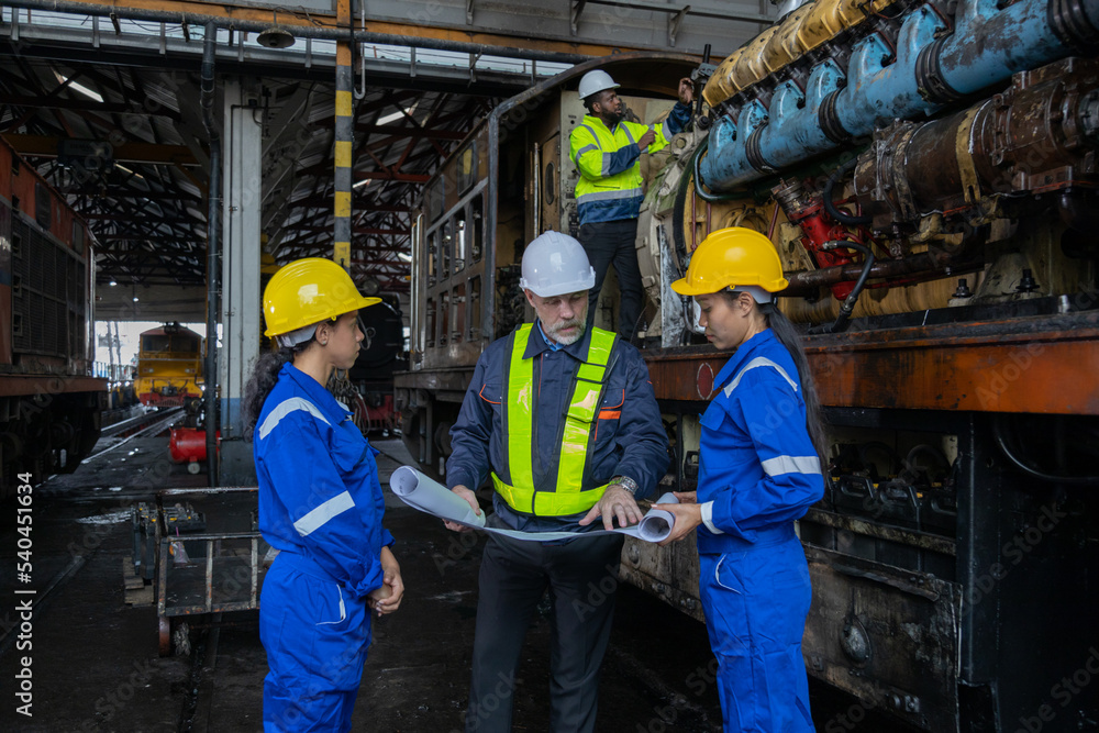 Railway engineer inspects diesel engine Report on the progress of engine parts in the factory. with safety standards Railway engineer inspects diesel engine Report on the progress of engine parts in the factory. with safety standards