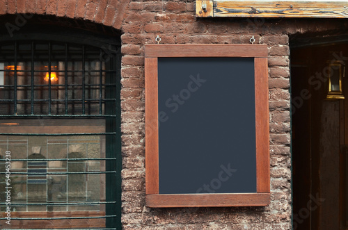 Photography Facade of building with blank advertising board on city street