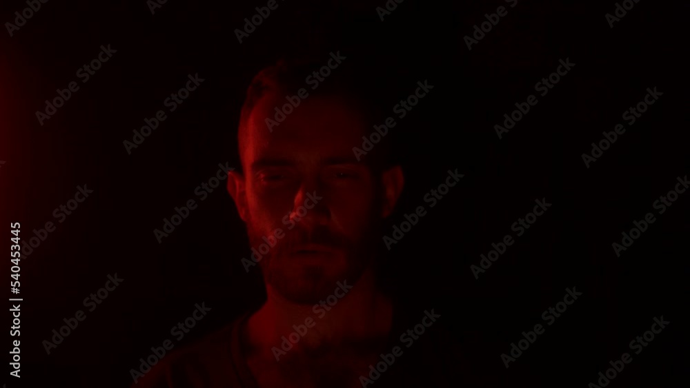 Angry man open eyes, awakes in hell, looking at camera with fury, rage, his face lit with fire flames, grief, sorrow. Male starring at enemy on war with aggresive emotions, insane devilish look. Angry man open eyes, awakes in hell, looking at camera with fury, rage, his face lit with fire flames, grief, sorrow. Male starring at enemy on war with aggresive emotions, insane devilish look.