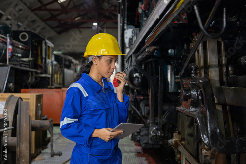 Railway engineer inspects diesel engine Report on the progress of engine parts in the factory. with safety standards