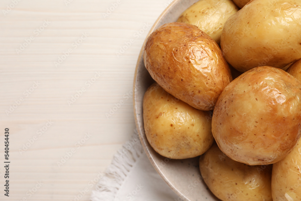 Delicious baked potatoes on white wooden table, top view. Space for text Delicious baked potatoes on white wooden table, top view. Space for text