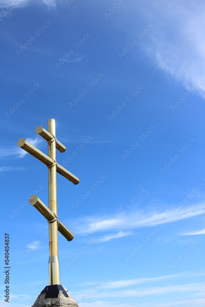 golden cross on a blue sky background