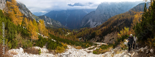 Autumn Mountains Panorama With Senior Couple Hiking Uphill - Vrsic Pass, Julian Alps Slovenia photo