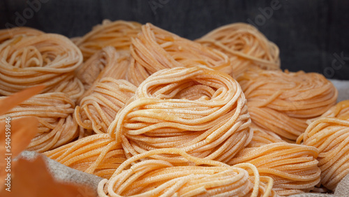 Canvastavla Raw linguini pasta sold in open bags at a street fair. Close-up