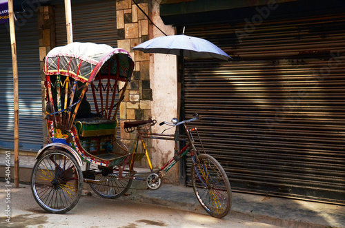 Classic antique vintage retro rickshaw trishaw bicycle of nepalese people for nepali passengers and foreign travelers use service journey in bazaar market old town at thamel city in Kathmandu, Nepal photo