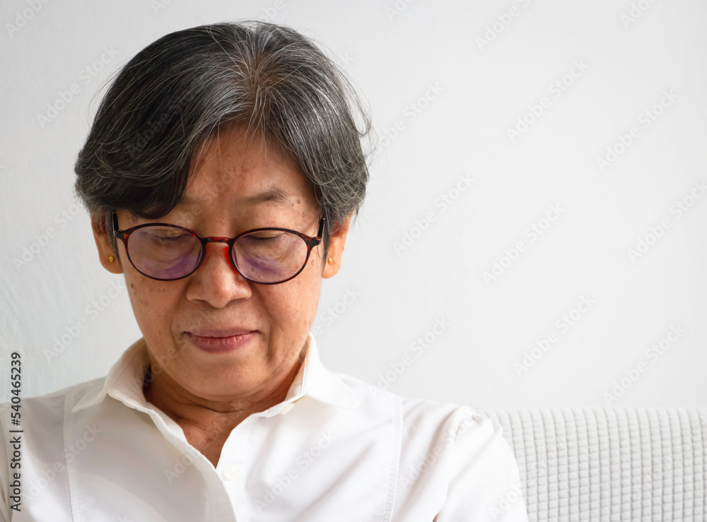 Old smart lady doing activity for relax time at living room Old smart lady doing activity for relax time at living room
