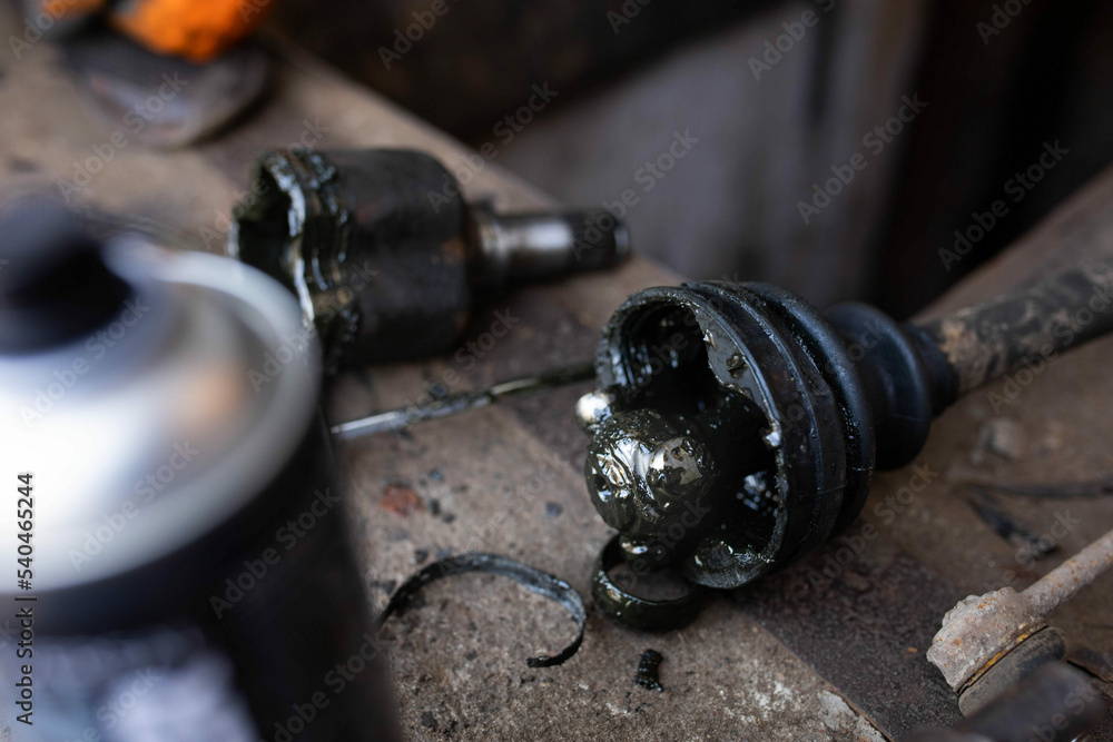 Repair and replacement of the axle shaft and CV joint with an anther of an automobile drive.