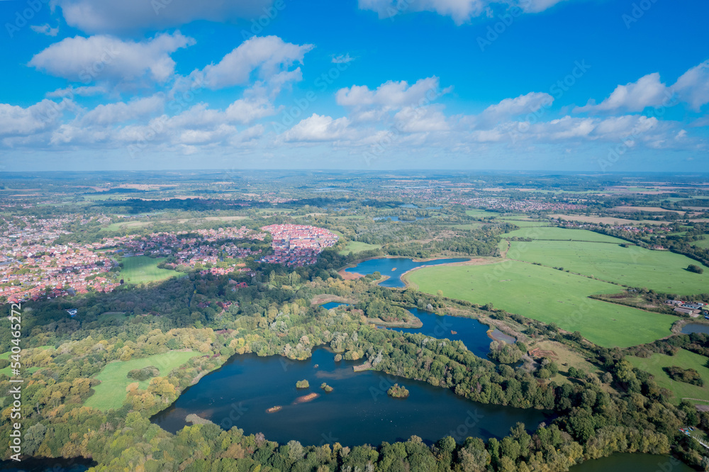 Beautiful aerial view of the Dinton Pastures Country Park, Black and White Swan Lake, and Winnersh Triangle